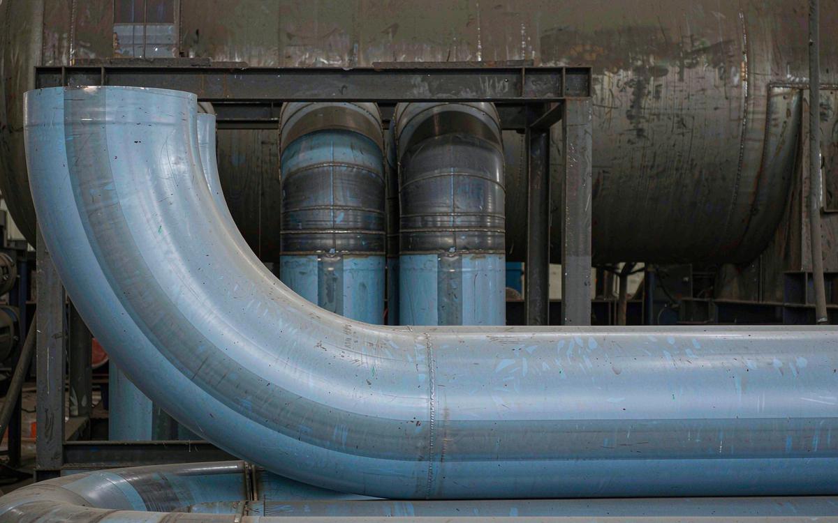 Clad pipe spools and induction bends in a fabrication yard