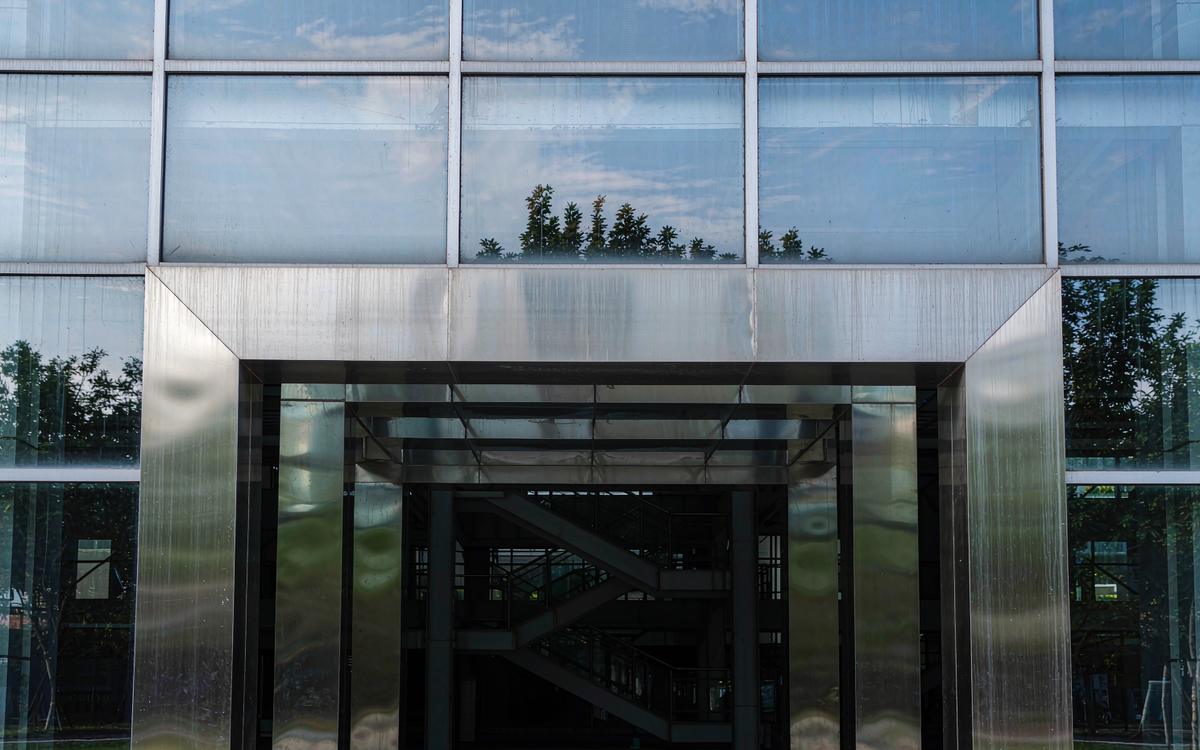 Building entrance with clad columns and facade panels
